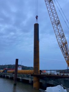 Tubular pile dropped into position